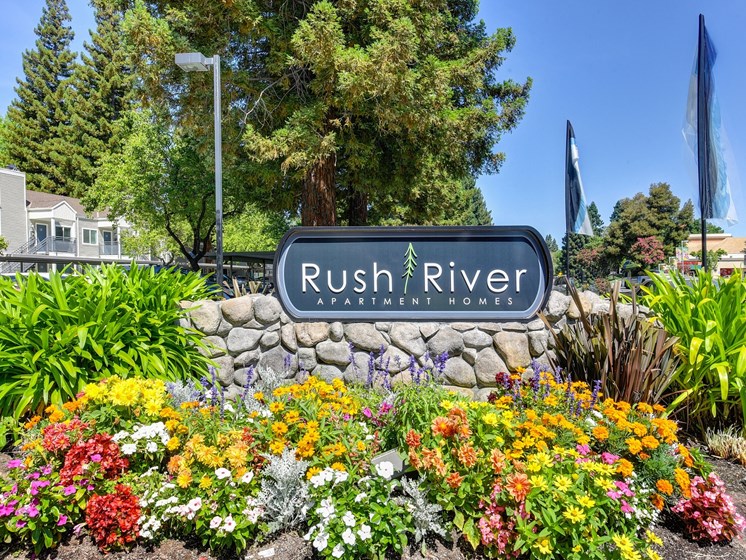 Rush River Monument Sign with Flower Bed, Trees and Plants